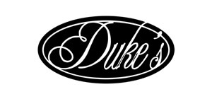 Duke's logo with elegant script on a black oval background, ideal for branding and identity recognition.